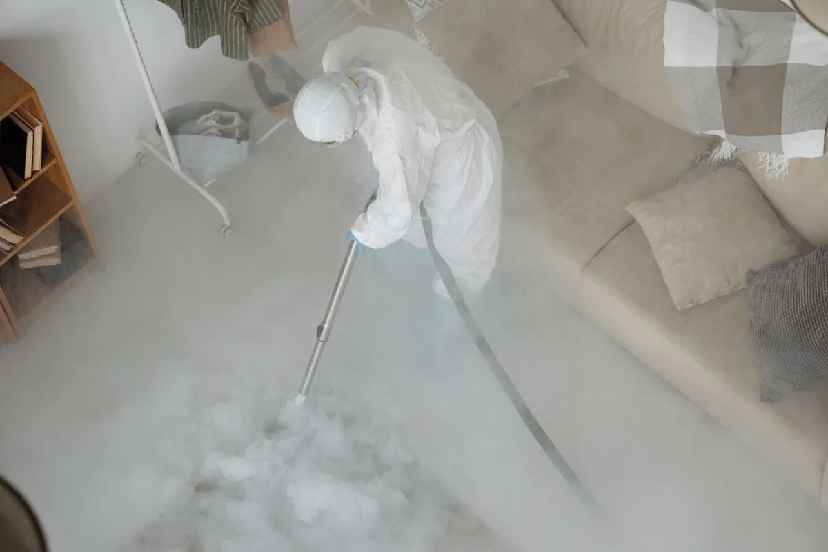 Biohazard cleanup technician in protective equipment, Hurley, MS